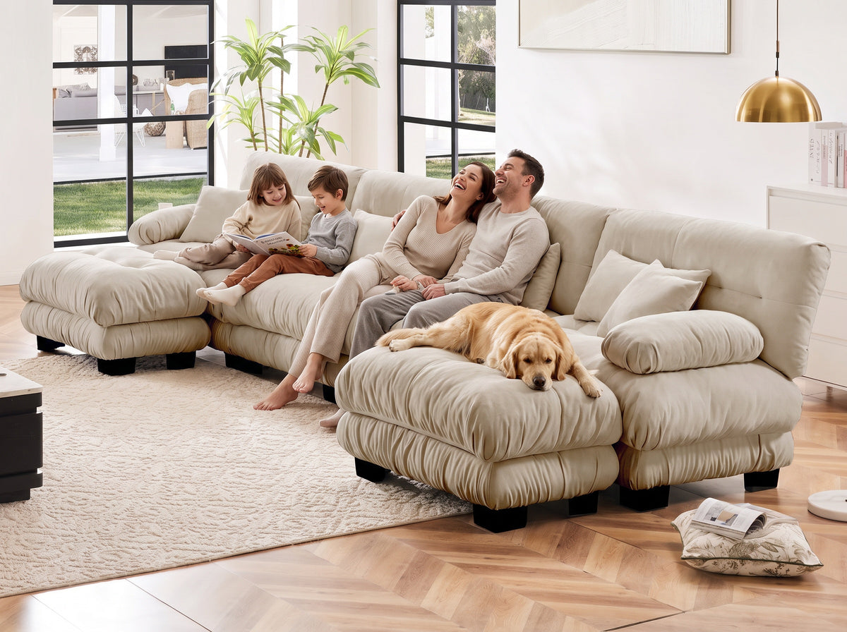 A family and their dog relaxing together on a Cloudies 4-seater with ottomans